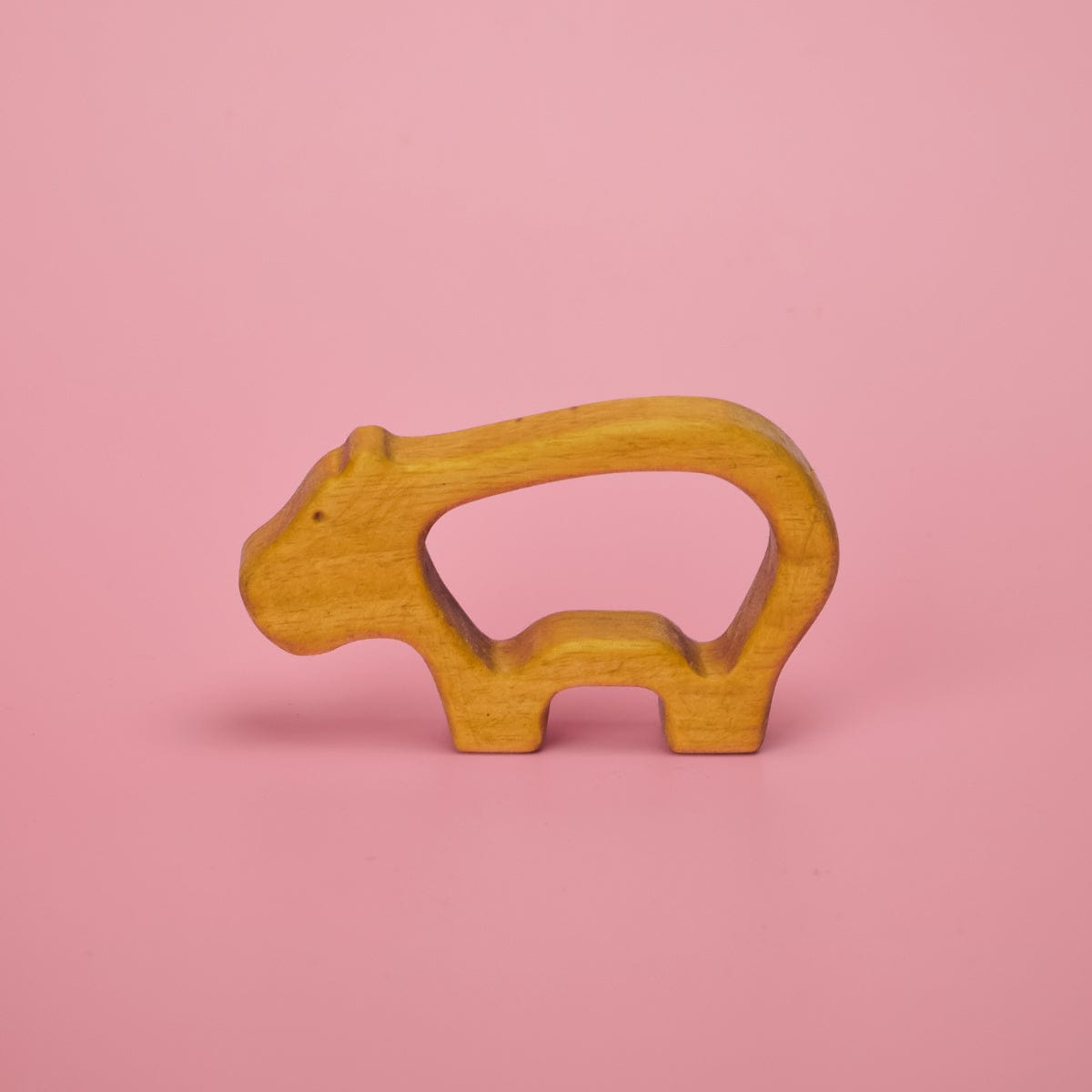 Wooden baby animal teether shaped like a hippo with grip-through hollow center for little hands