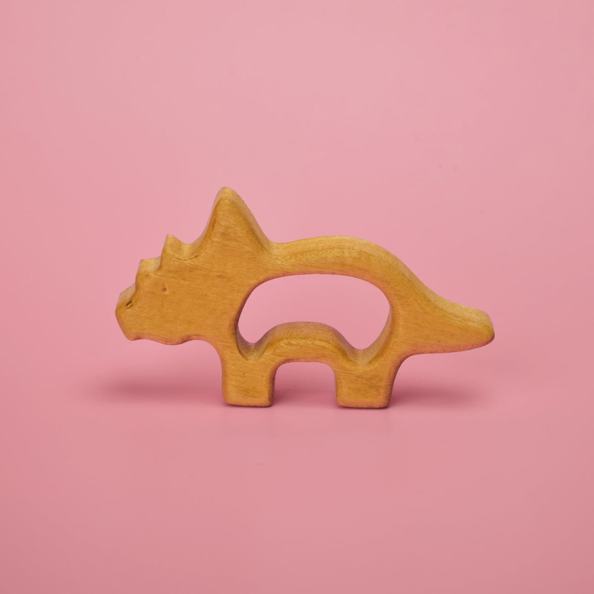 Wooden baby dinosaur teether shaped like a brontosaurus with food-safe mineral oil finish