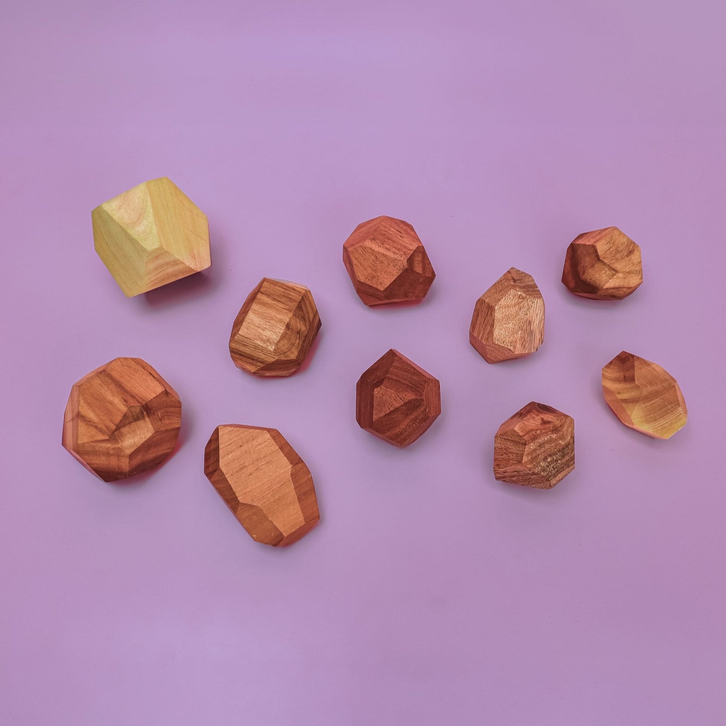 Smol Rocks wooden stones stacked in cairn towers showing beautiful acacia wood grain patterns