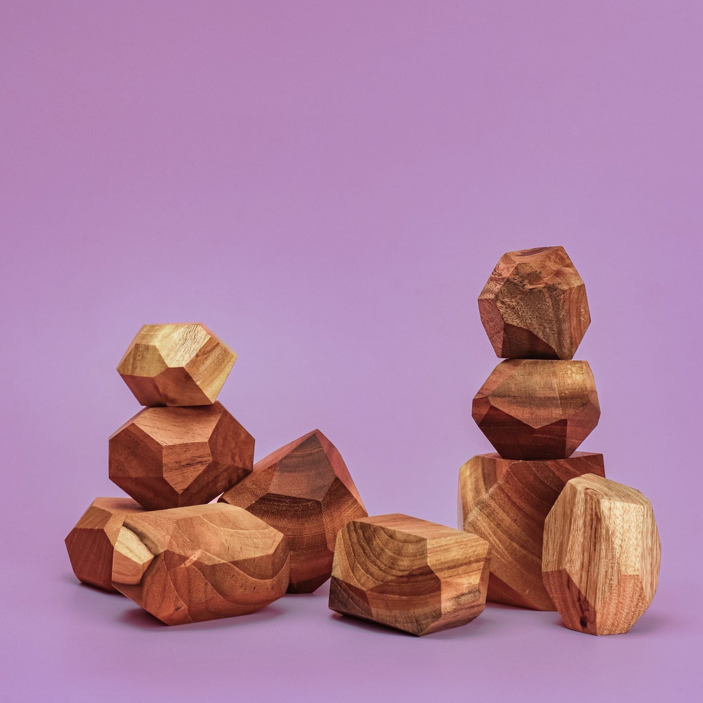 Smol Rocks set of 10 hand-carved wooden stacking stones in various geometric shapes with natural grain